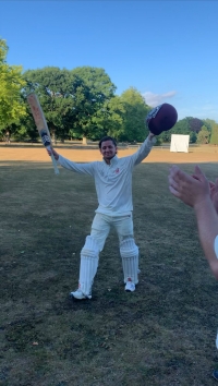Sam celebrating his maiden ton in successful chase at Falconhurst